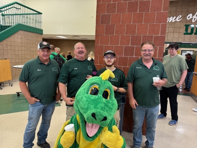 Dizzy Dragon poses with the maintenance staff during breakfast
