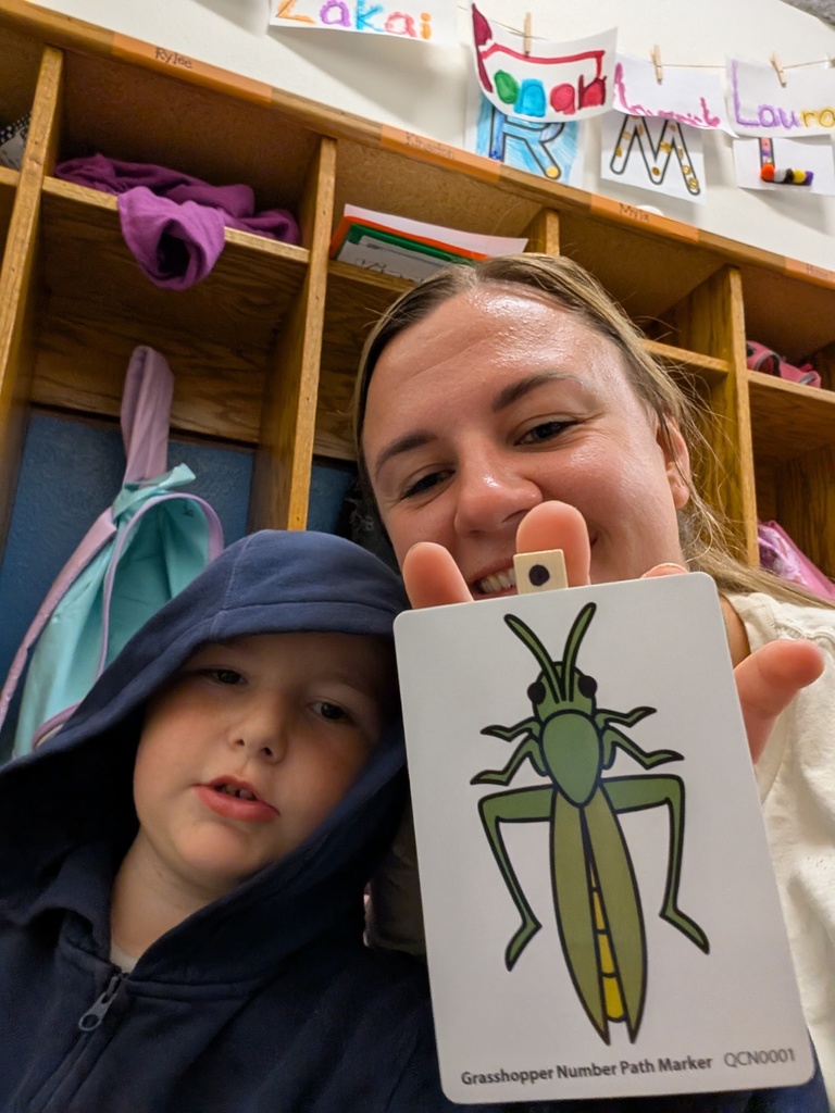 Student and teacher show off their grasshopper flashcard