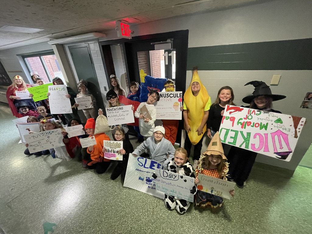 Group photo of 4th grade students in Ms. Miller's classroom with their vocabulary parade costumes