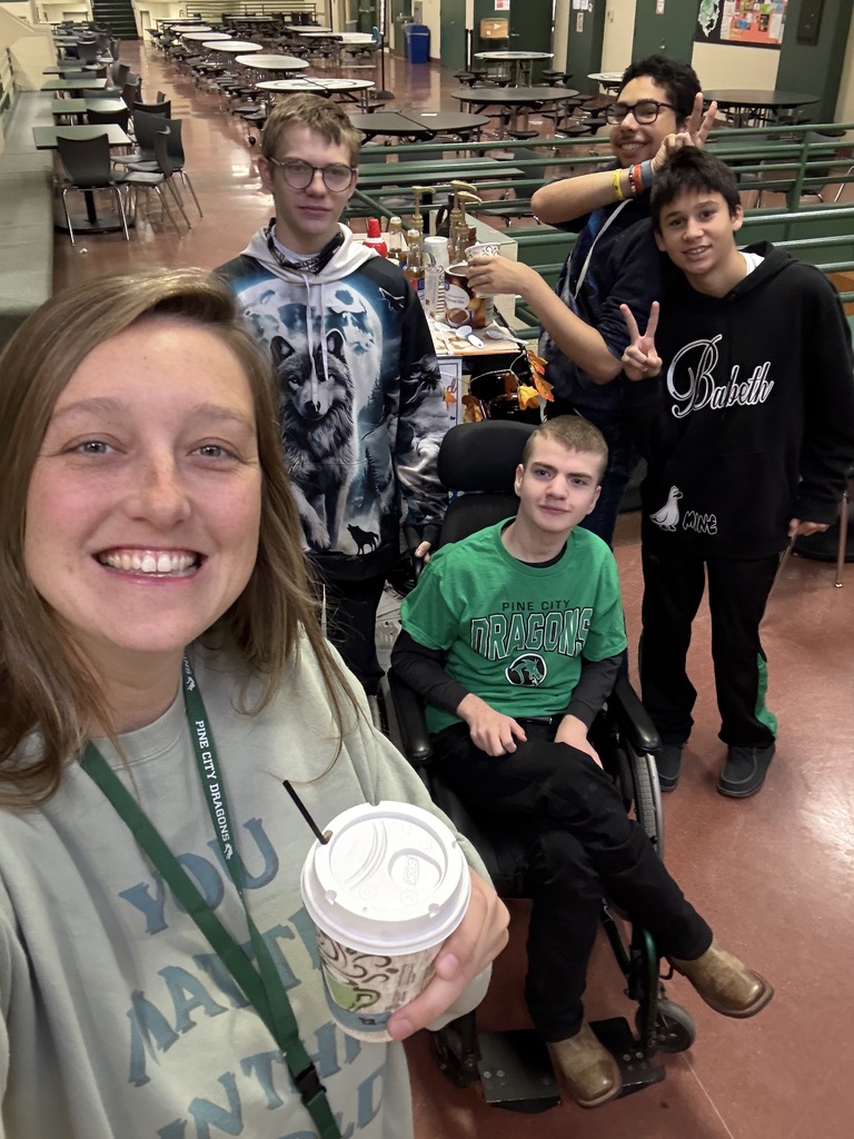Pine City teacher with cup of coffee from the coffee cart student delivery team.
