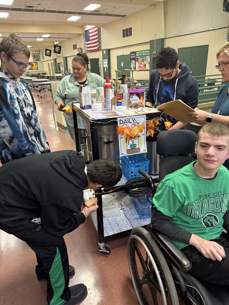 The Daily Grind coffee cart with the students and staff who manage the service for the high school. 