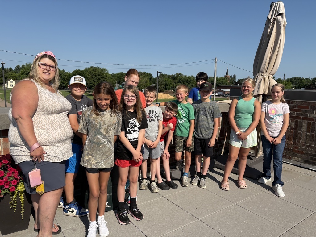 4th grade students enjoying the view from the rooftop patio during their summer field trip.