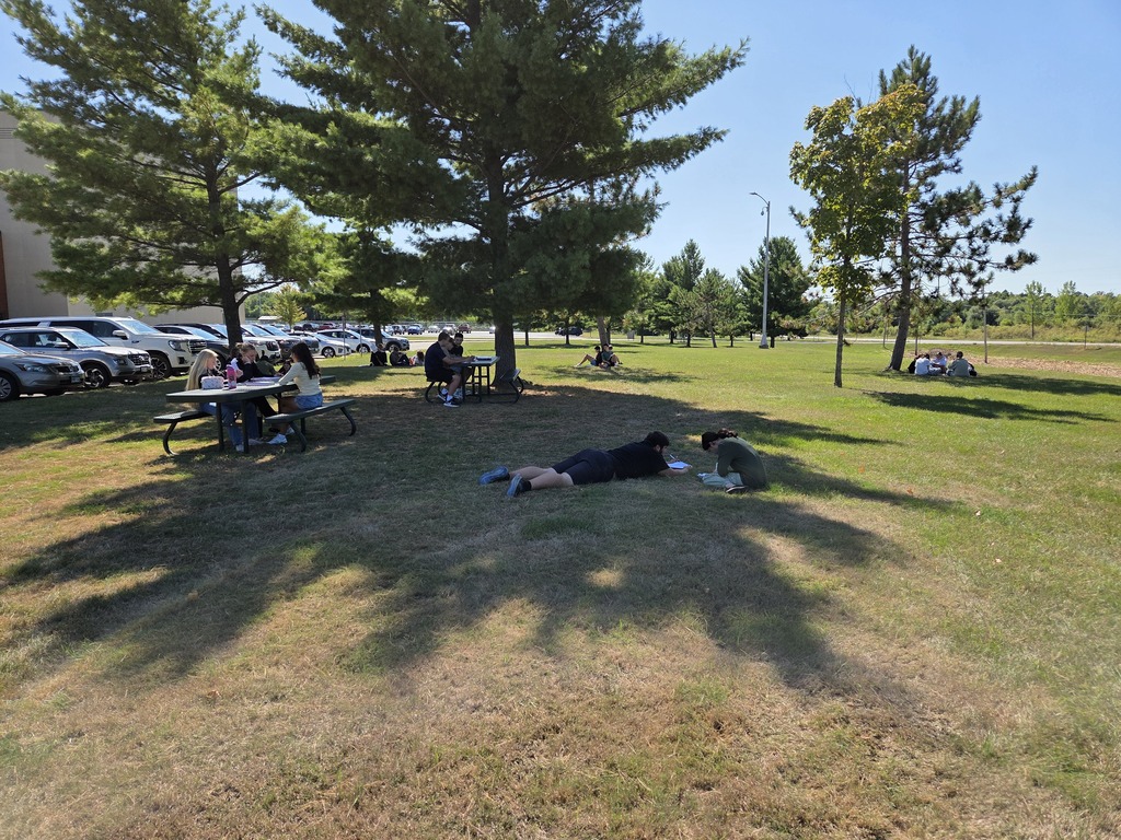High school students enjoying Geometry class outdoors on a fall day. 