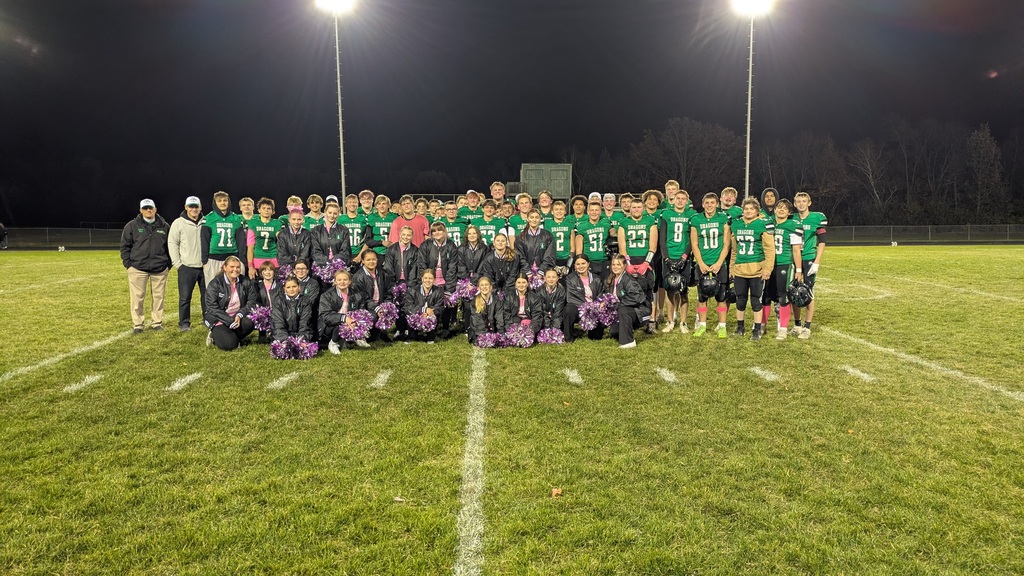 Dragon football players and cheerleaders on the field.