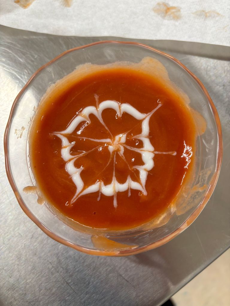 pictures of tomato soup with designs on top