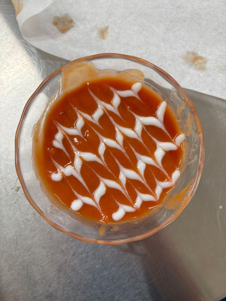 pictures of tomato soup with designs on top