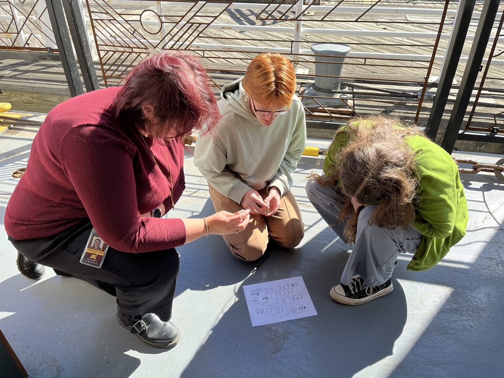 3 students with map