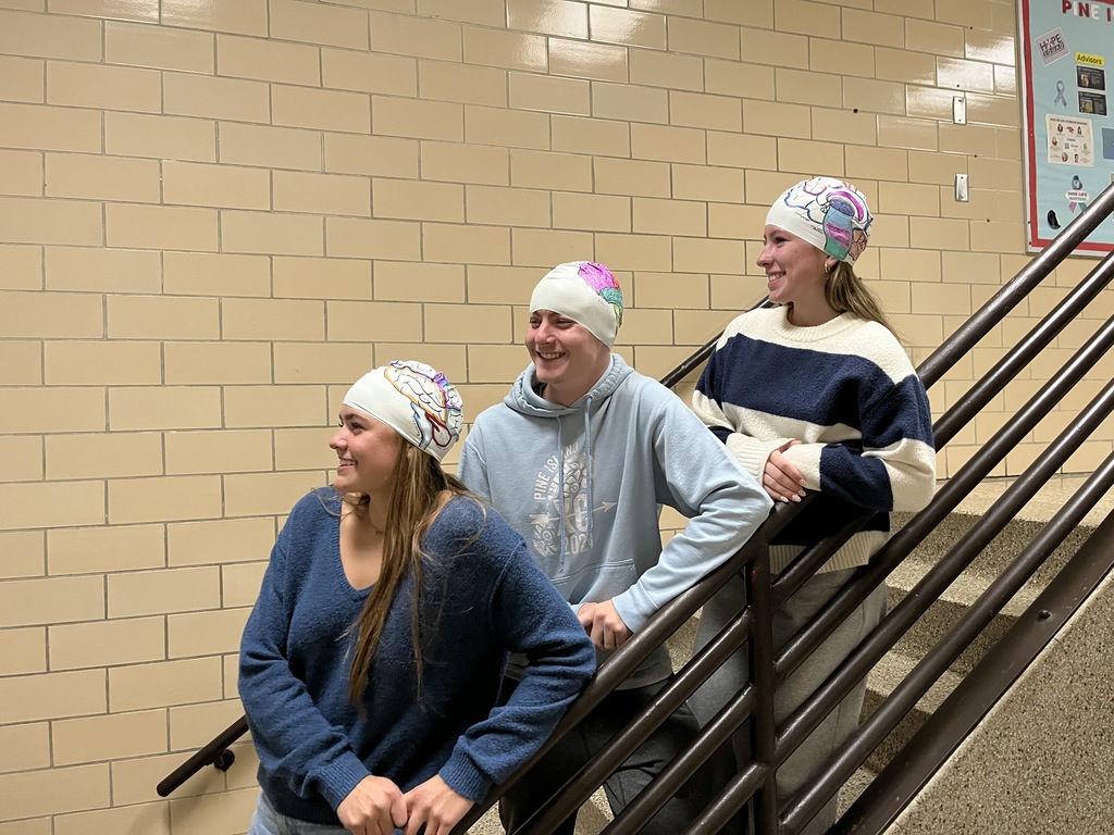 3 students with swim caps on 