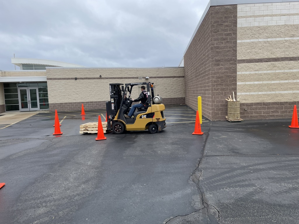 Student learning to drive forklift