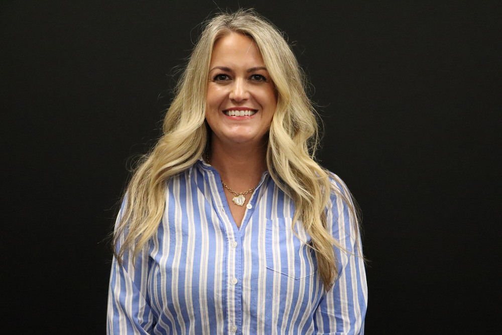 Pioneer Tech woman in striped shirt with blonde hair