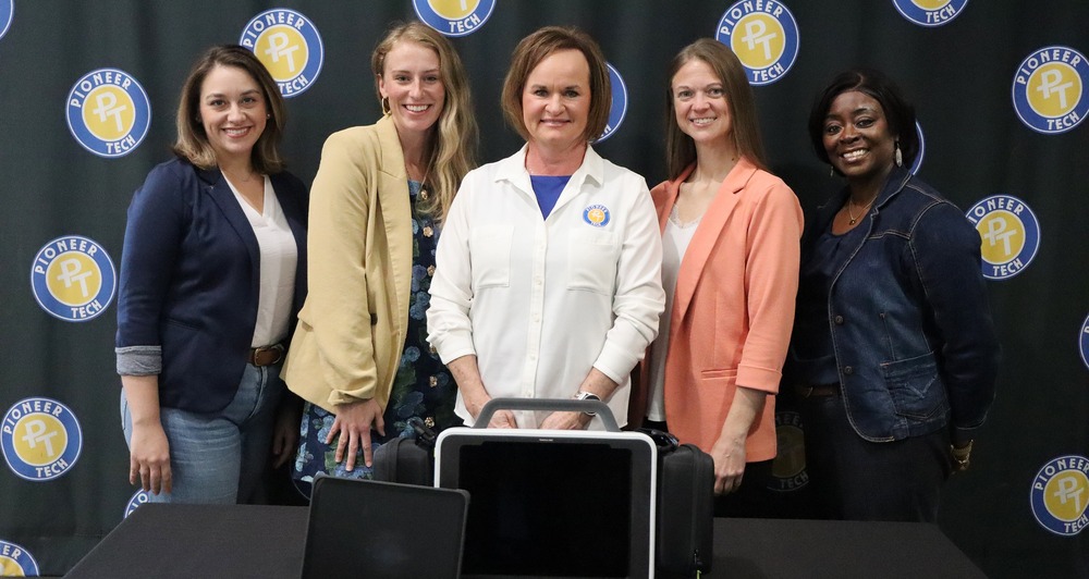 Apryl Moore, Kay County Community Health Foundation Board Member; Derion Schieber, Executive Director, Kay County Community Health Foundation; Traci Thorpe, Pioneer Tech Superintendent/CEO; Staci DeNoya, AT&D Program Facilitator; and Markesha Duggan, AT&D Coordinator behind the Laerdal Monitor