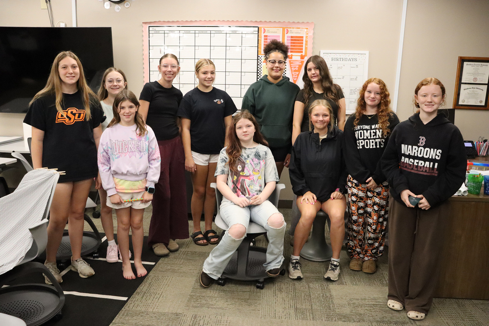 Group of girls in a classroom smiling