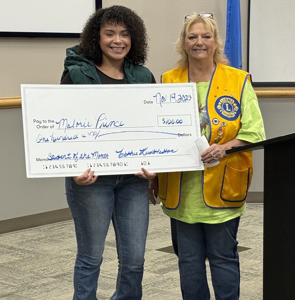 Pioneer Tech Student Ambassador of the Month holding check