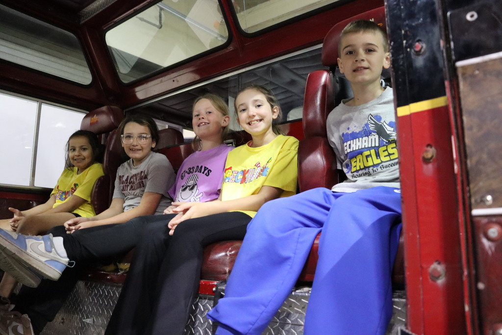 Pioneer Tech third grade students sitting in fire truck. 
