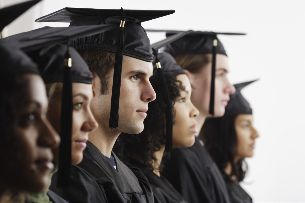 Graduates both male and female standing in a line.