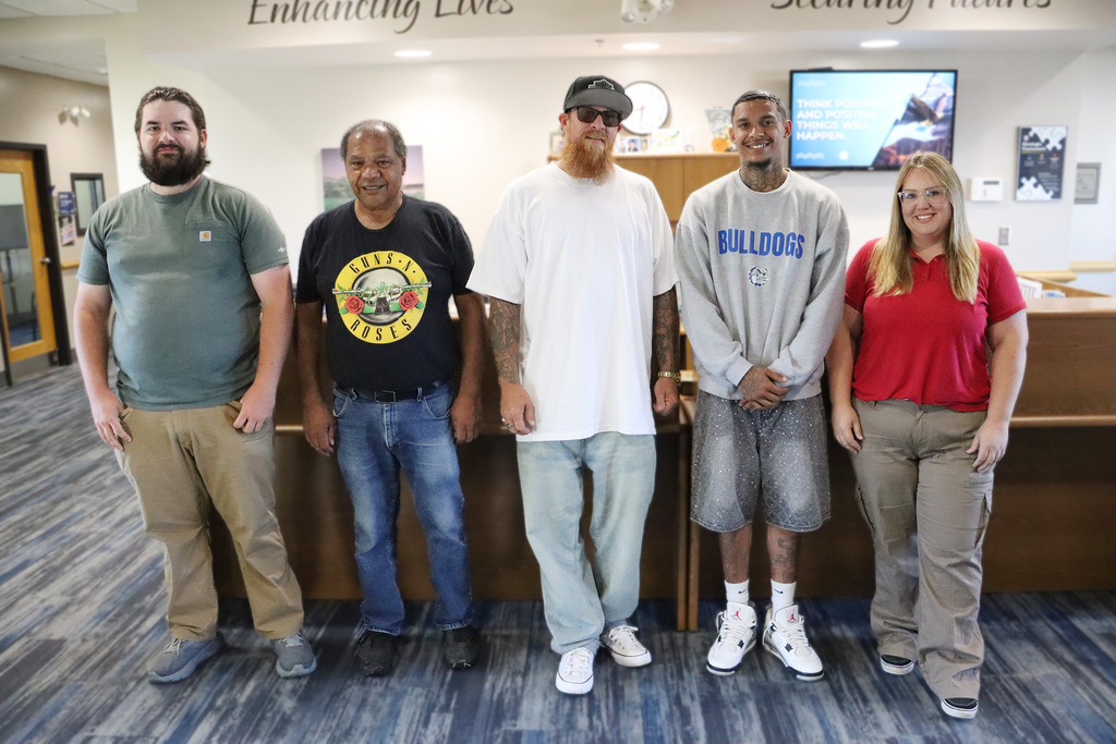 Pioneer Tech Graduates from the Truck Driver Training Class, 4 males and a female standing in line. 