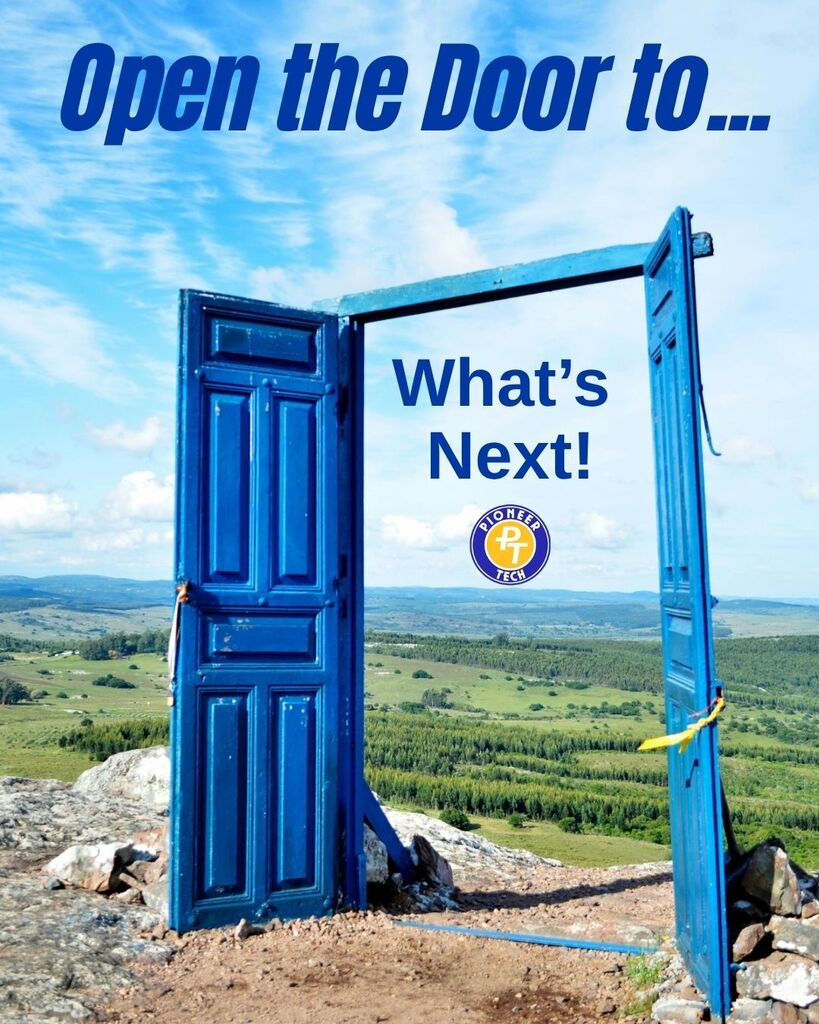 Blue open door standing alone on a hill overlooking a vast green landscape under a bright sky.
