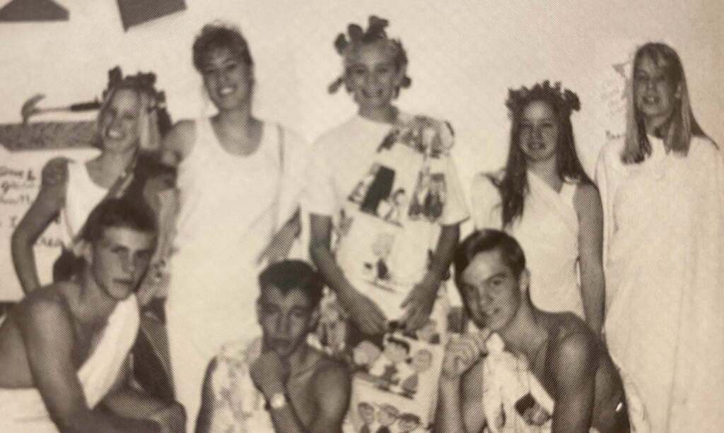 Throwback Thursday photo of 5 girls and 3 boys dressed in toga outfits for Homecoming