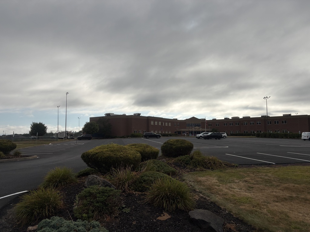 Image of the parking lot in front of the Primary Center. Showing left row reserved for visitors. The middle and right rows for permit parking only.