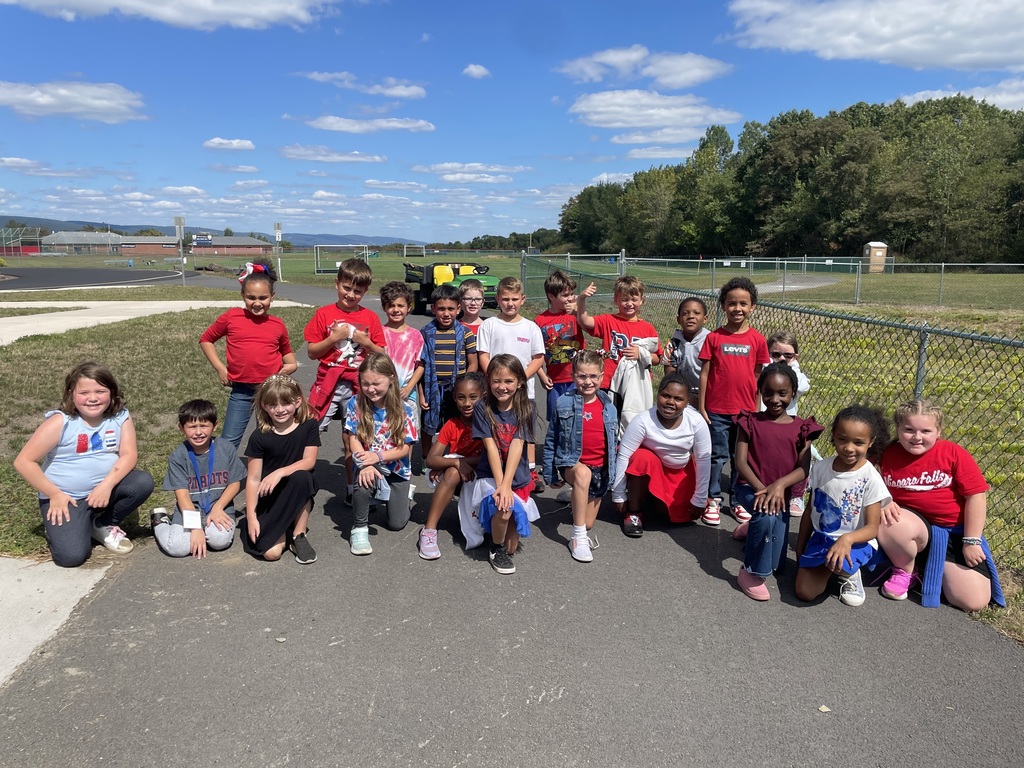 A group photo of 2nd grade students dressed in red, white and blue to celebrate Patriot day, 