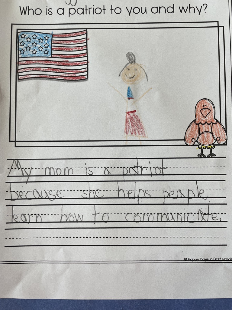 Student writing with illustration about a patriot. With student drawing and clipart of the american flag and eagle. 