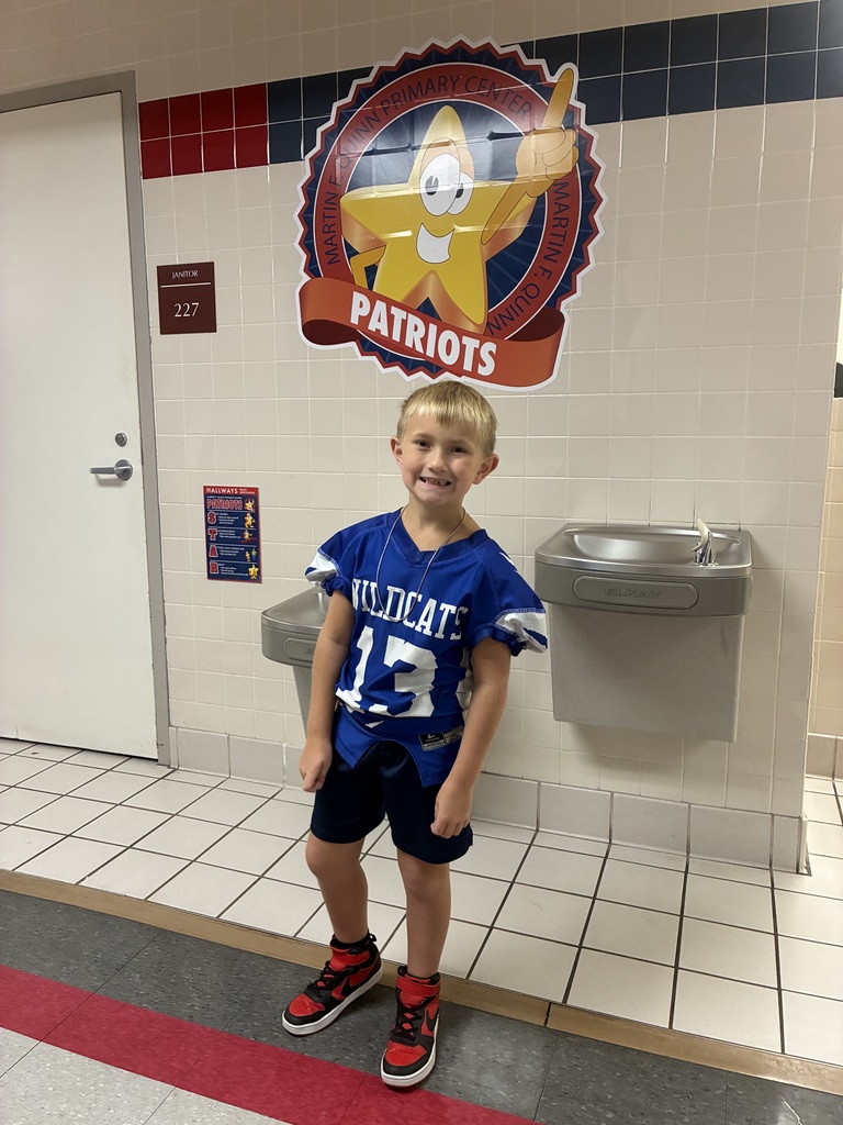 A wildcat football player in a football pose at school