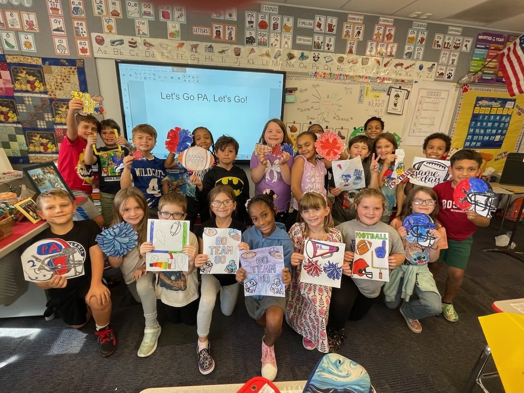 In the photo, Mrs. Zambetti’s class is gathered together in their colorful classroom, proudly holding up handmade football-themed posters, pom-poms, and signs showing support for the team. Their smiles and creativity shine as they send their best wishes to the players.