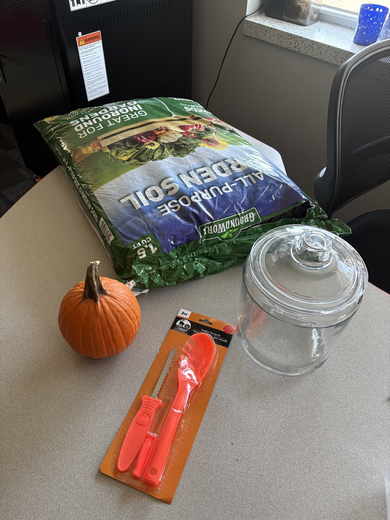 A bag of soil, a pumpkin, carving tools and a glass jar on a table.