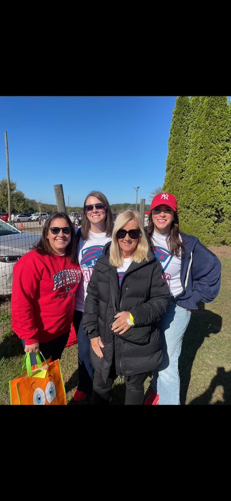 A group of teachers in pittston area shirts smiling at the camera.