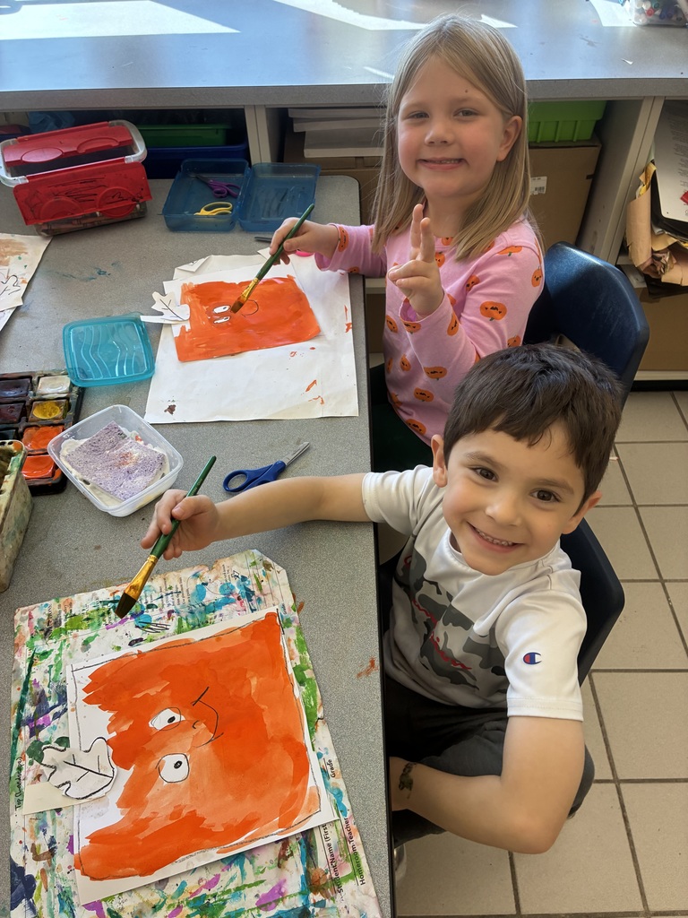 Students painting pumpkin art.