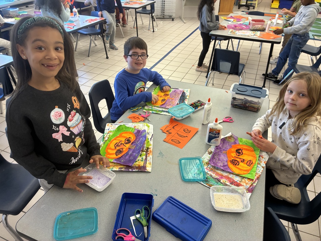 Students painting pumpkin art.