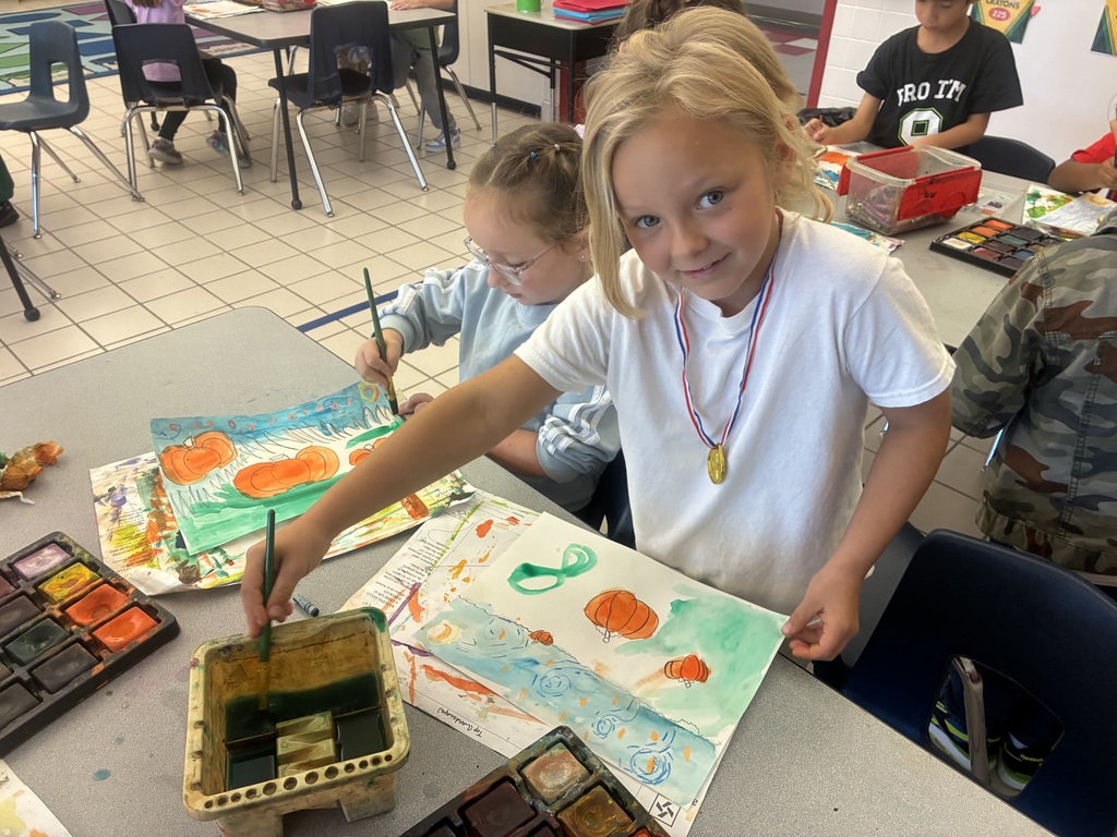 Students painting pumpkin art.