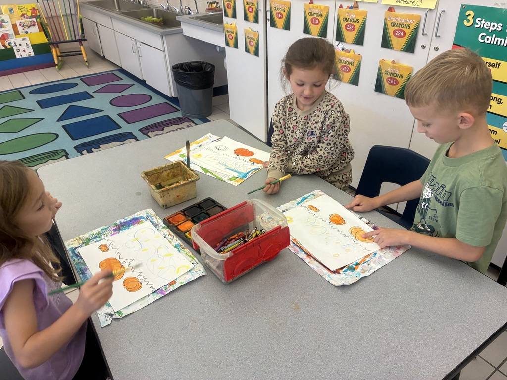 Students painting pumpkin art.