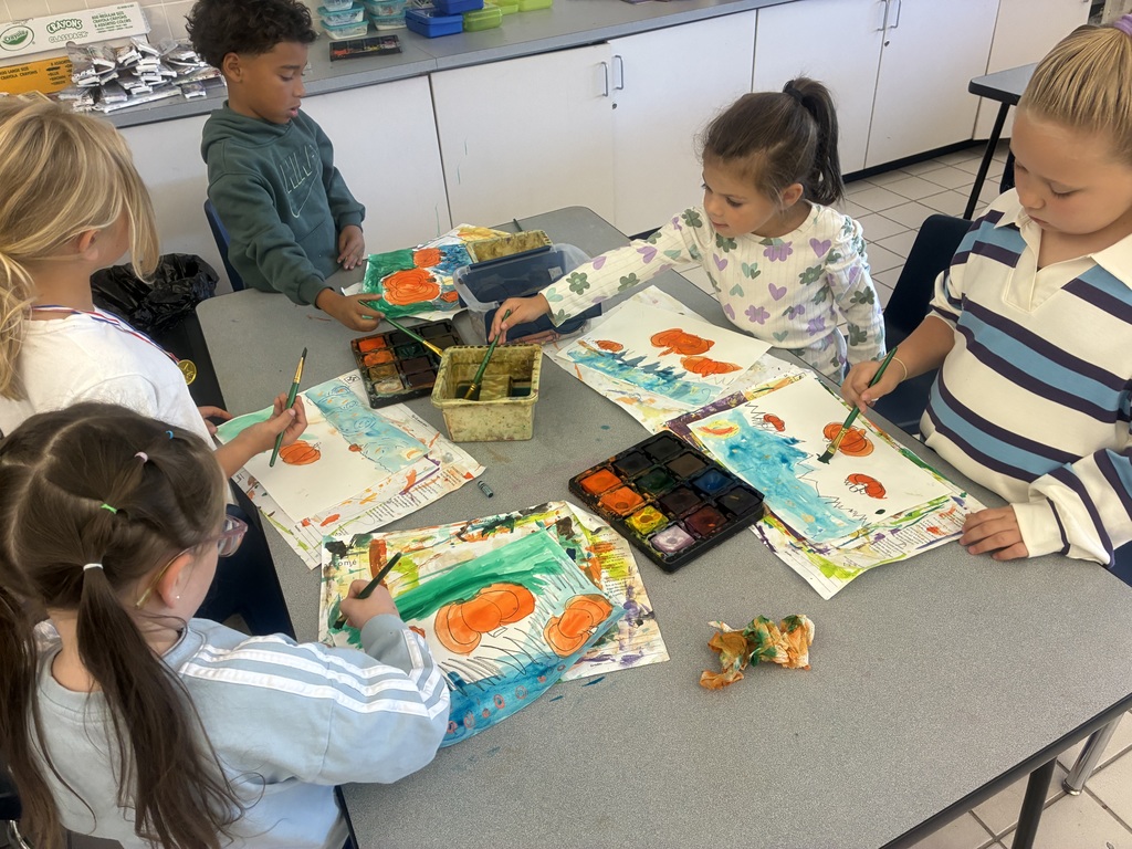 Students painting pumpkin art.