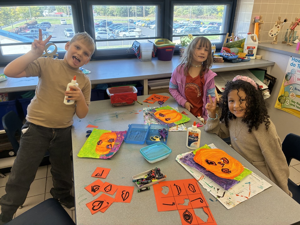 Students painting pumpkin art.