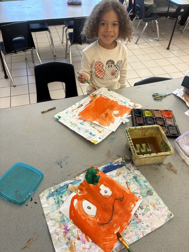 Students painting pumpkin art.