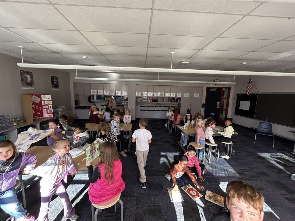 Kids in a science stem lab classroom reading books about plants.