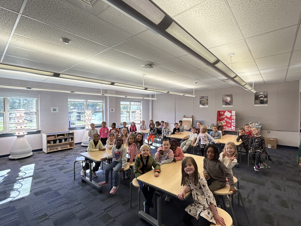 A class in a stem classroom seated at tables