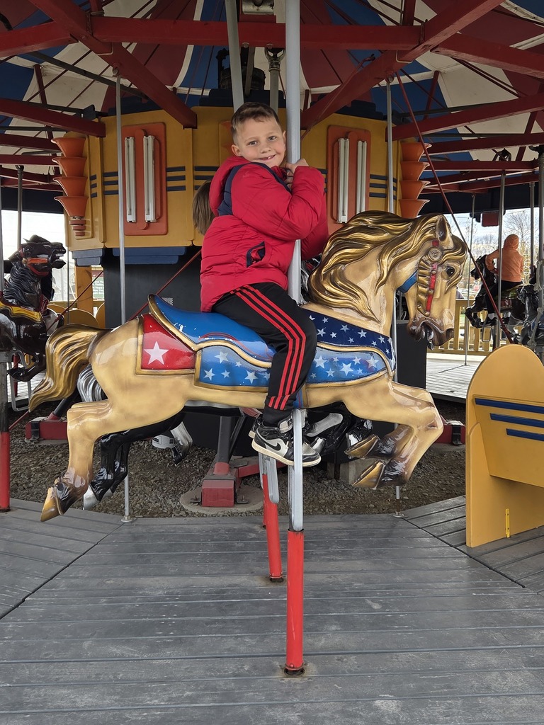 A kid on a carousel.