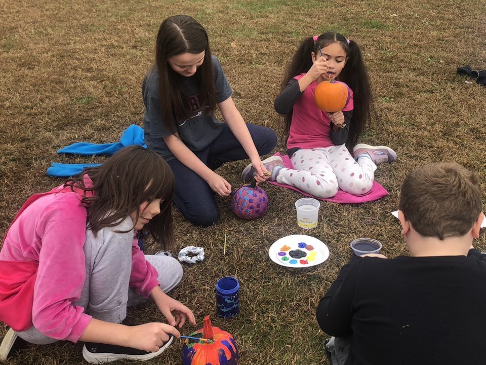 Kids painting pumpkins