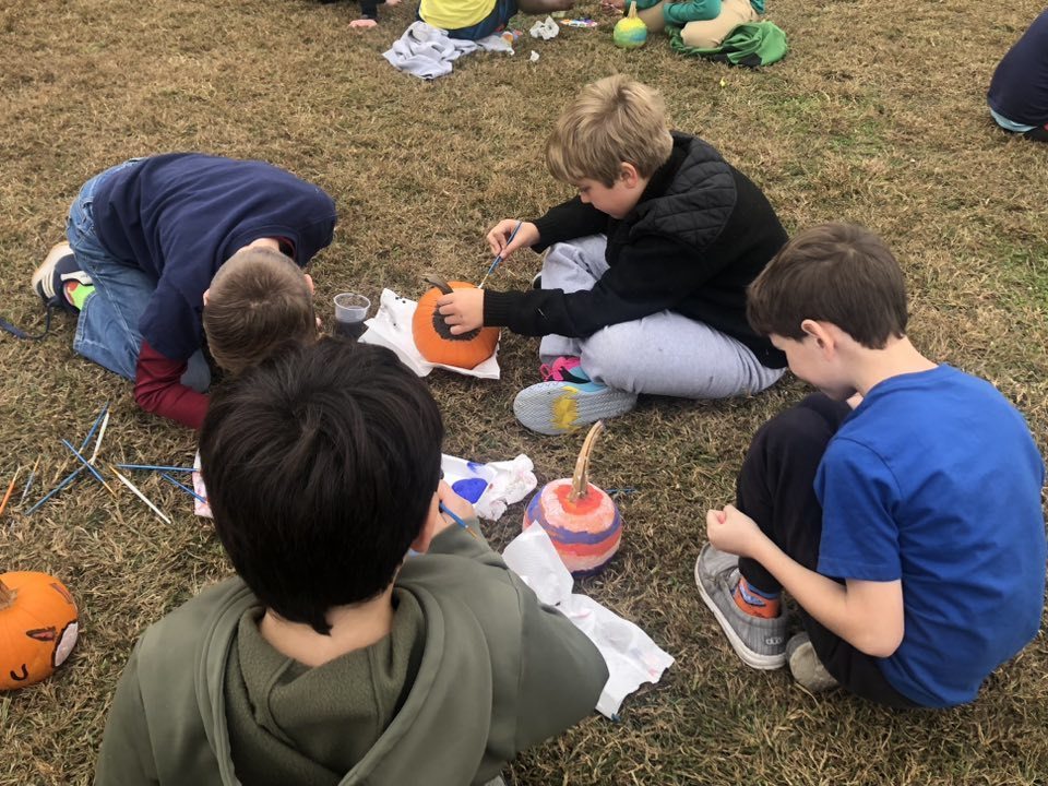 Kids painting pumpkins