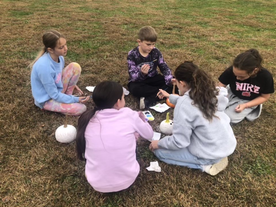 Kids painting pumpkins