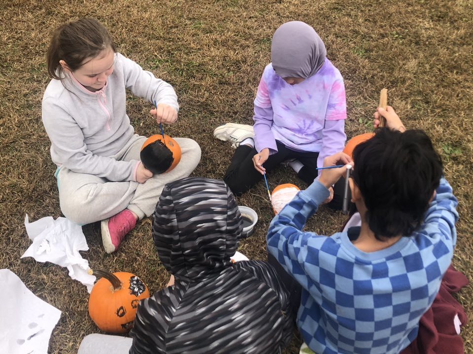Kids painting pumpkins