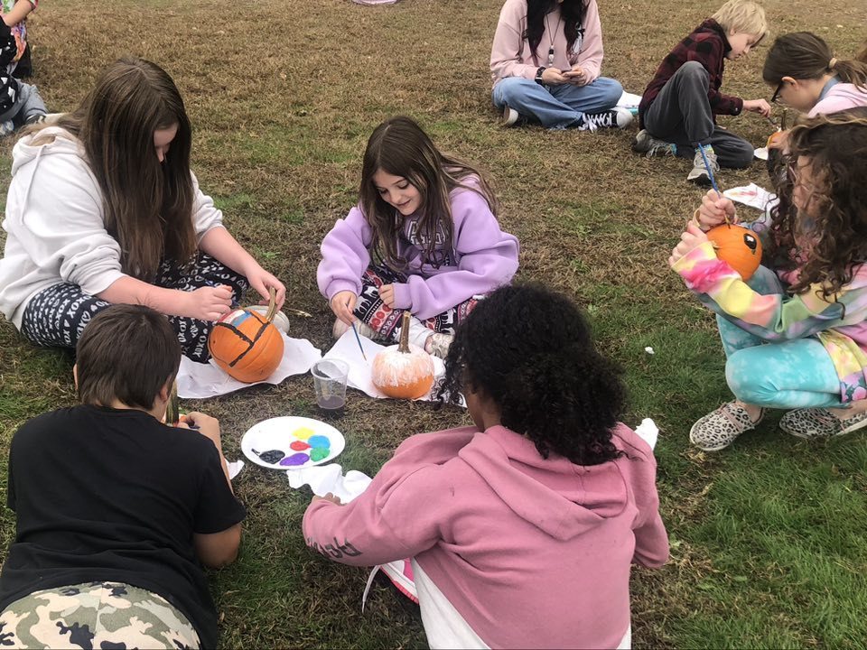 Kids painting pumpkins