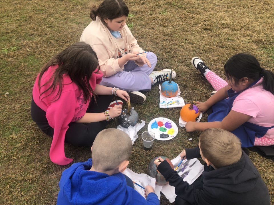 Kids painting pumpkins