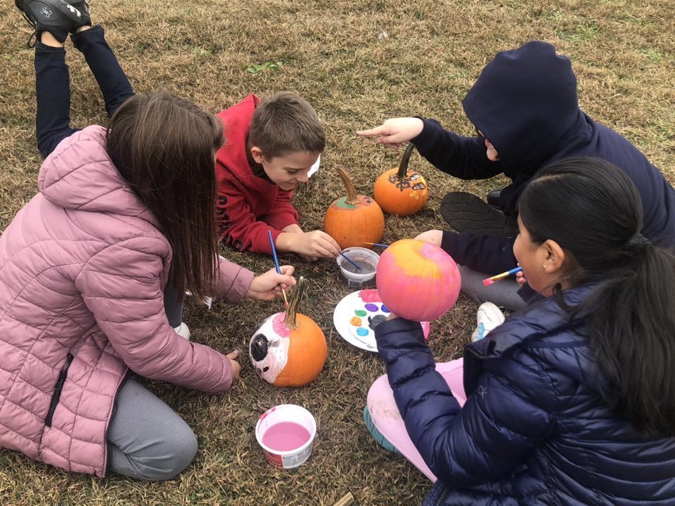 Kids painting pumpkins