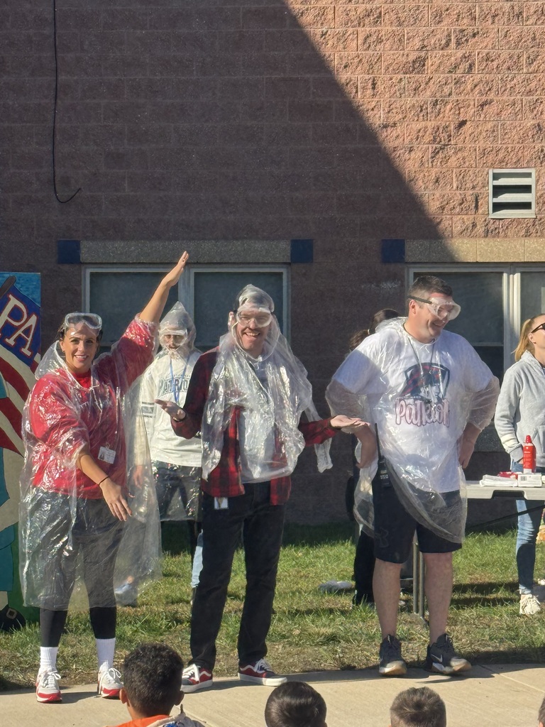 Four teachers in clear plastic ponchos and googles.