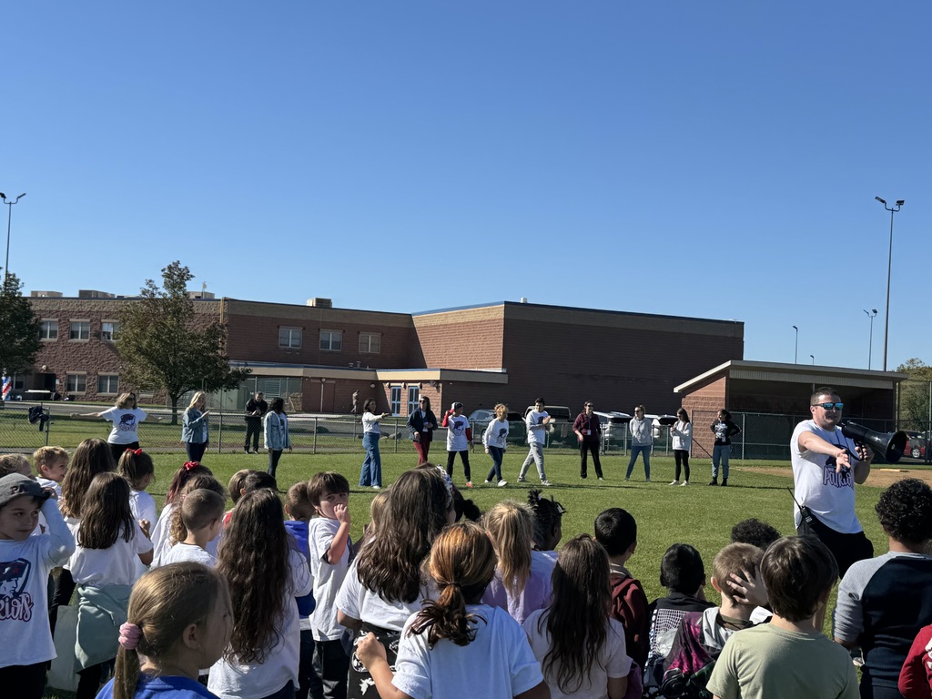 A crowd of students looking at teachers lined up to race.