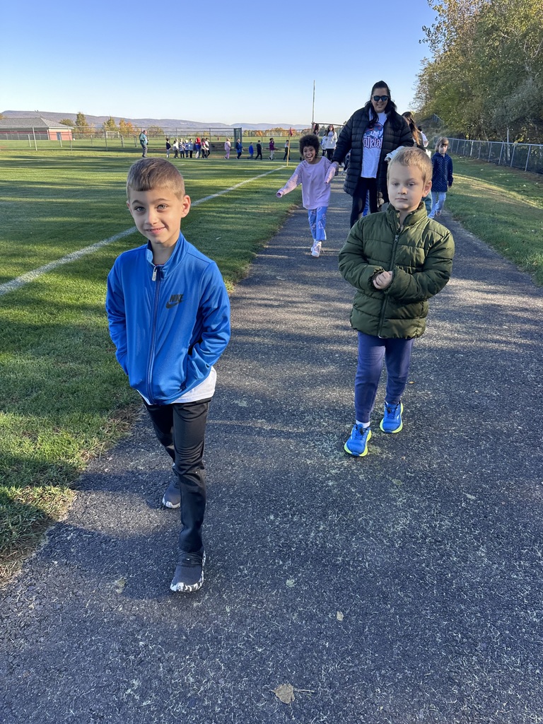 Students walking on an outdoor track.