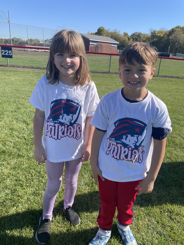A boy and a girl smiling at the camera.